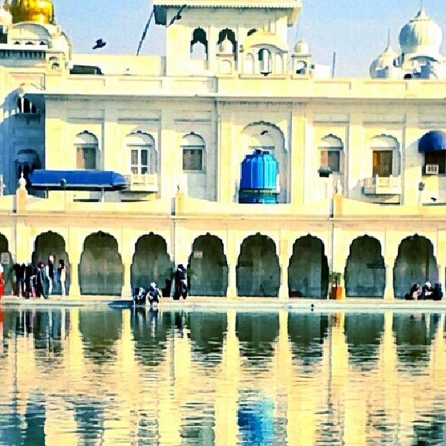 architecture, built structure, building exterior, arch, water, facade, reflection, incidental people, travel destinations, architectural column, dome, waterfront, city, tourism, travel, outdoors, men, famous place, clear sky