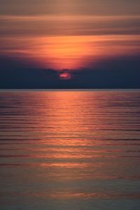 Scenic view of sea against romantic sky at sunset