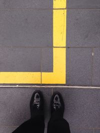 Low section of woman standing on tiled floor