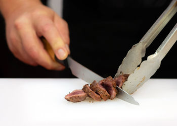 Close-up of person preparing food on table