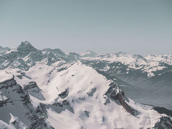 Scenic view of snowcapped mountains against clear sky