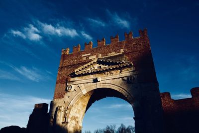 Low angle view of historical building against blue sky