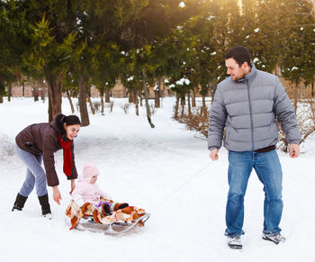 Full length of father and son standing on tree