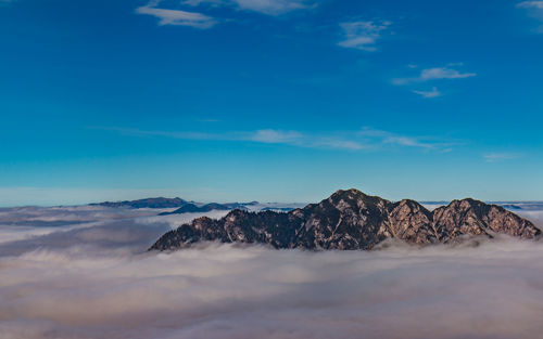 Scenic view of mountain against blue sky