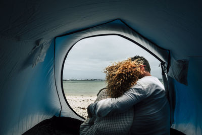 Rear view of woman in sea against sky