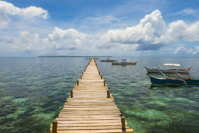 Pier over sea against sky