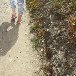 Low section of woman standing on ground