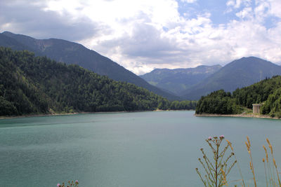 Scenic view of lake and mountains against sky