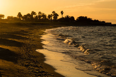 Scenic view of beach against sky during sunset