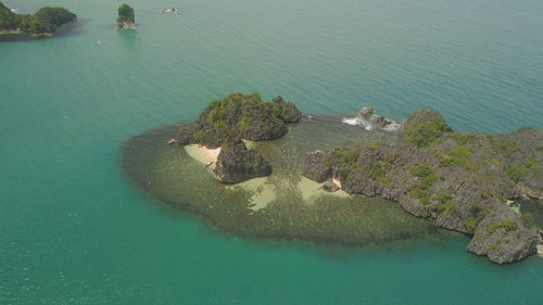 High angle view of rocks on sea shore