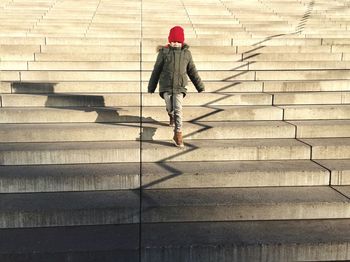 Low angle view of boy moving down from steps