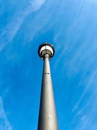 Low angle view of communications tower against sky