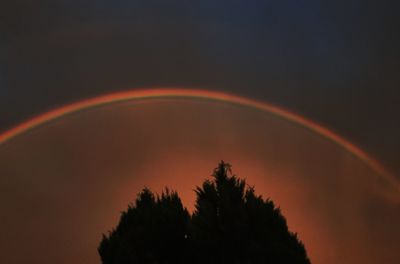 Scenic view of rainbow against sky at sunset