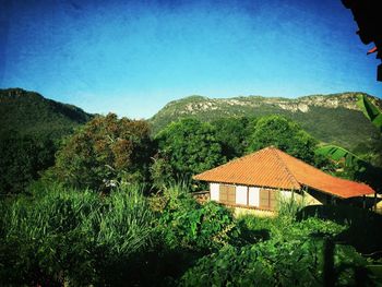 Houses on mountain against clear sky