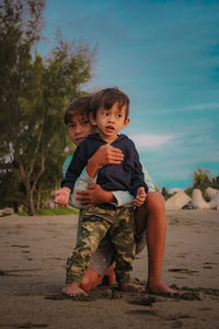 Full length portrait of cute boy lying on land