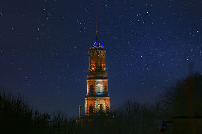 Low angle view of illuminated building against sky at night