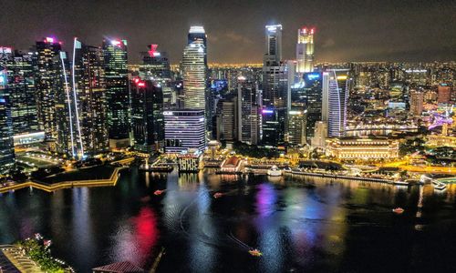 Illuminated city at waterfront