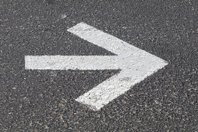 High angle view of arrow sign on road