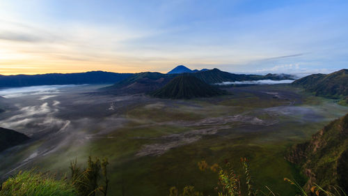 View of volcanic landscape against sky during sunset