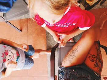 High angle view of girl sitting on sofa at home