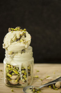 Close-up of pistachio ice cream in glass jar