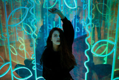 Portrait of young woman standing in aquarium