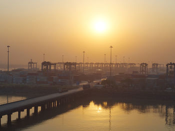 Scenic view of harbor against sky during sunset