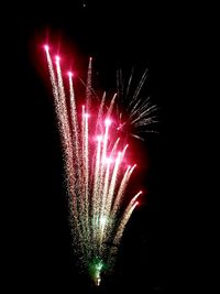 Low angle view of firework display at night