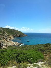 Scenic view of sea against blue sky