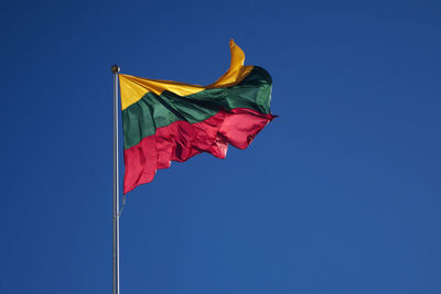 Low angle view of lithunian flag against clear blue sky