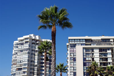 Low angle view of modern building against blue sky