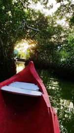 Close-up of red boat moored in lake