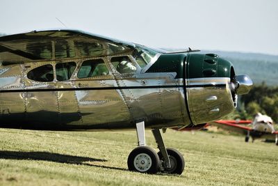 Airplane on airport runway against sky