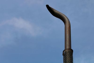 Low angle view of smoke stack against sky