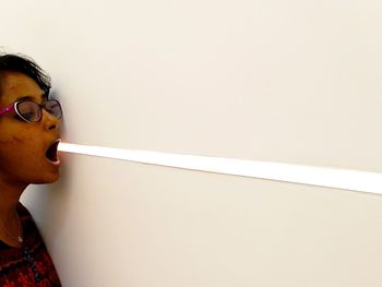 Portrait of boy looking away against wall