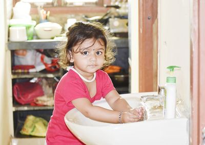 Portrait of cute girl sitting at home