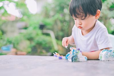 Cute boy playing with toy