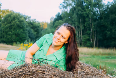 Young woman on haystack.