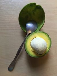 Directly above view of avocado and spoon on table