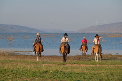 People riding horses on a field