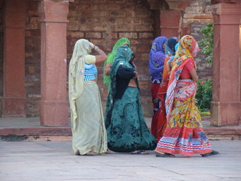 Women walking against building