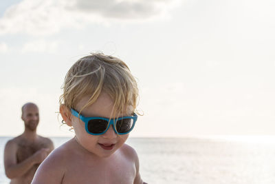 Smiling boy standing at beach