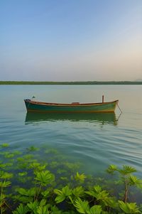 Boat in sea against clear sky