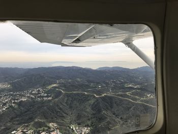 Aerial view of landscape seen through airplane window