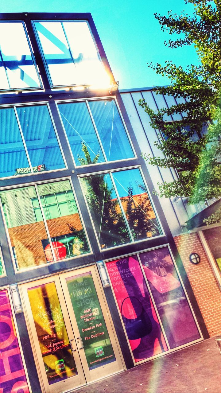 architecture, built structure, window, glass - material, building exterior, low angle view, reflection, multi colored, building, day, transparent, house, sky, sunlight, indoors, no people, residential structure, residential building, modern, pattern