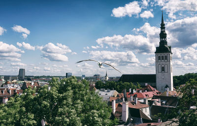 View of townscape against cloudy sky