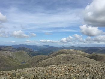 Scenic view of mountains against cloudy sky