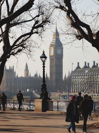 People on street while big ben in background