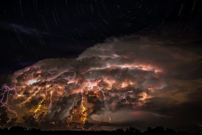 Low angle view of illuminated sky at night