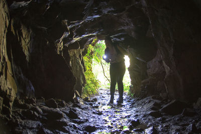 Full length of woman standing in cave